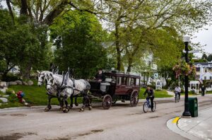 Mackinac - Michigan. Picture of the streets with horse and wagon transport, you can also see a bike.